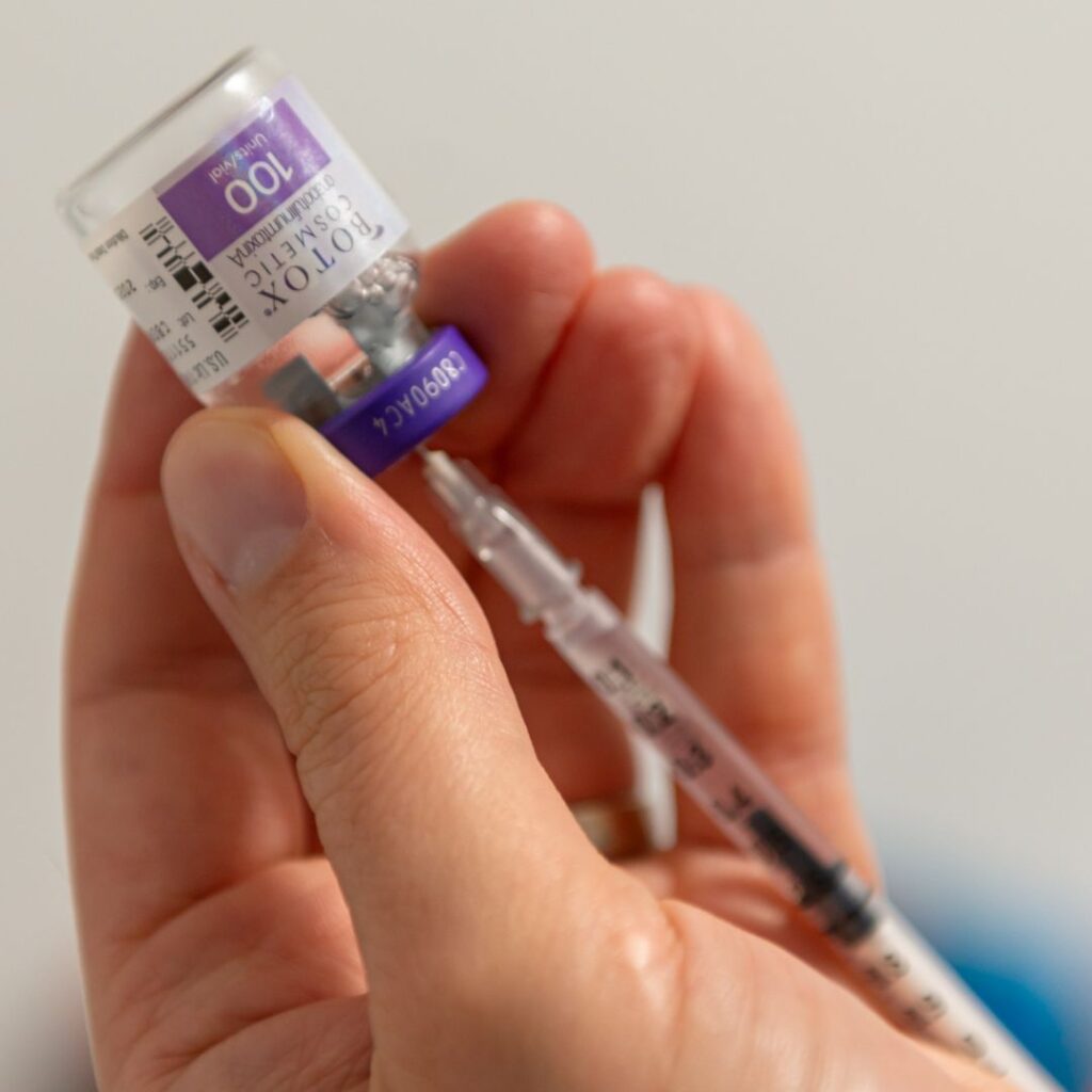 Dr Bloom holding a vial of Botox with a needle